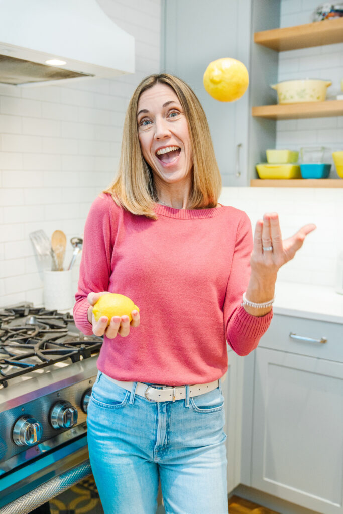 Nutritionist juggling lemons on a kitchen while getting new brand photos
