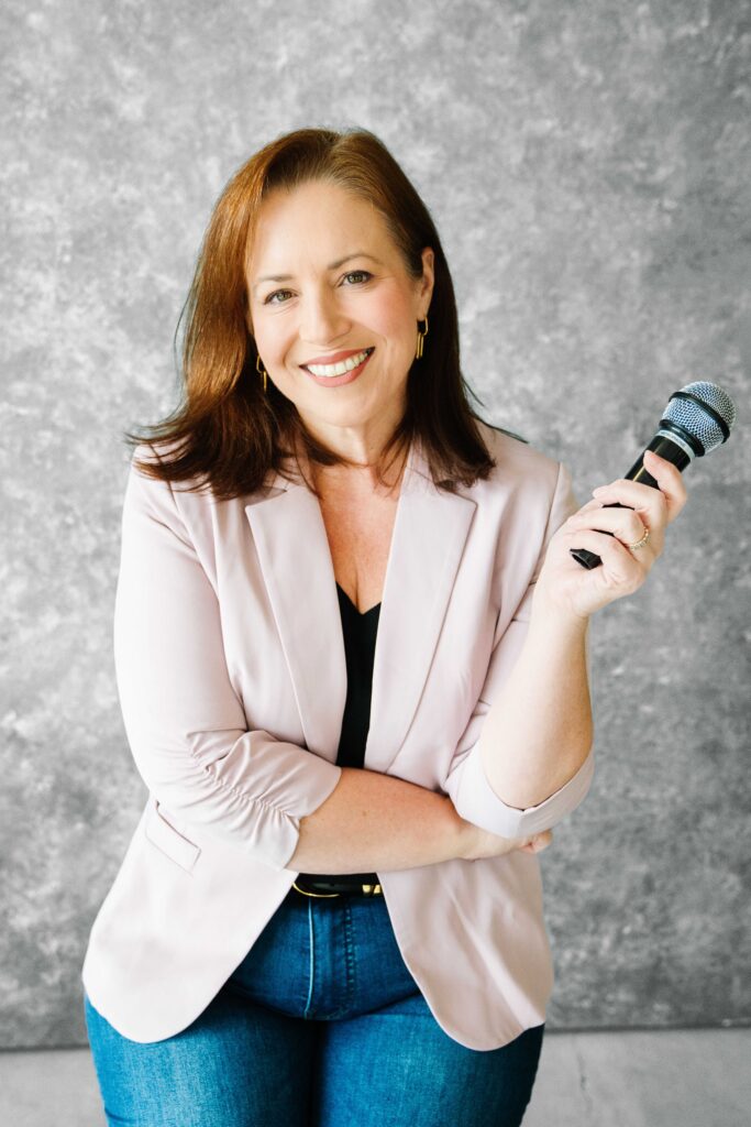 Keynote speaker posing with a microphone for her new brand photos 