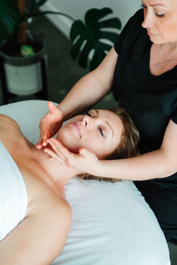 Photo of a massage therapist giving a massage to a client during a brand photography session in Portland, Oregon.