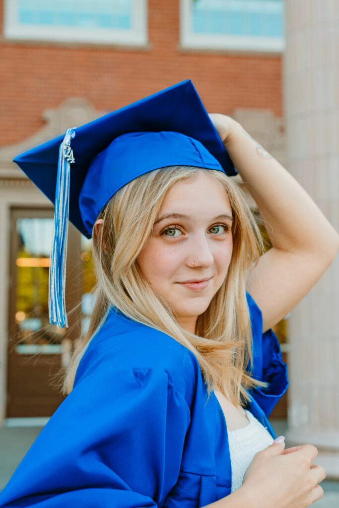 High school girl during  graduation wearing a cap and gown.
