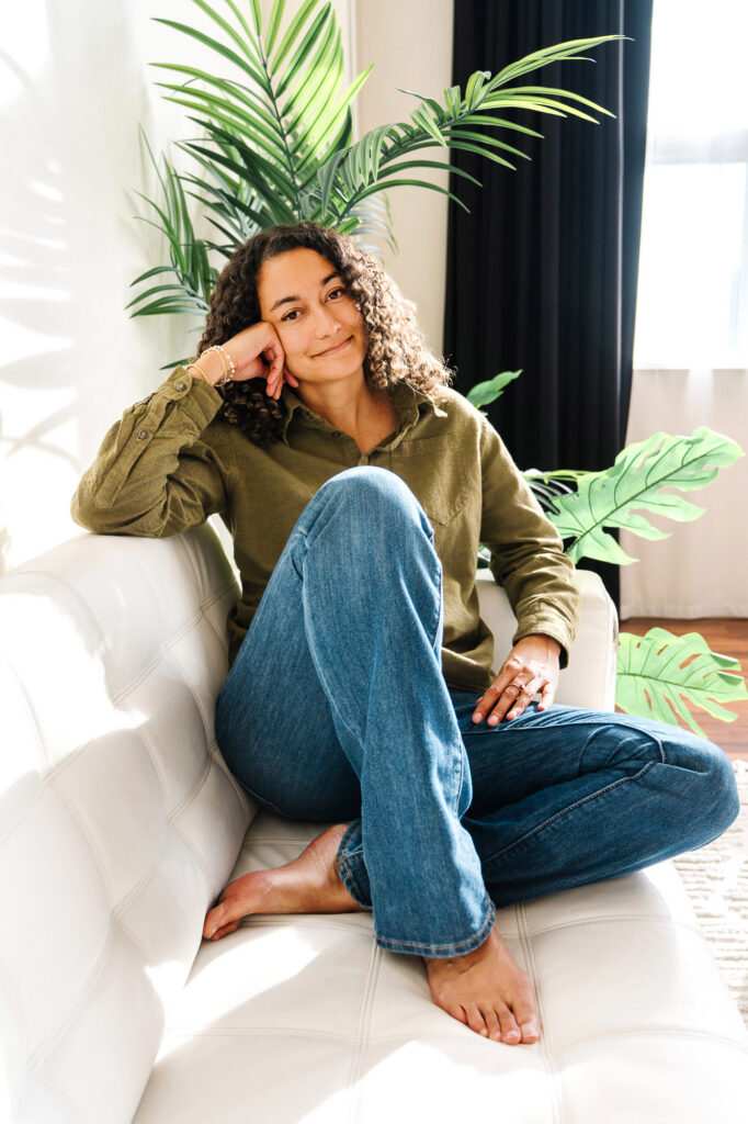 Mental health therapist sitting on a couch barefoot and feeling comfortable in front of the camera w