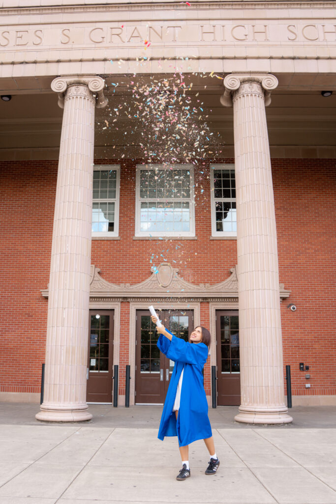 High school girl launching confetti in the air during her professional  graduation photos