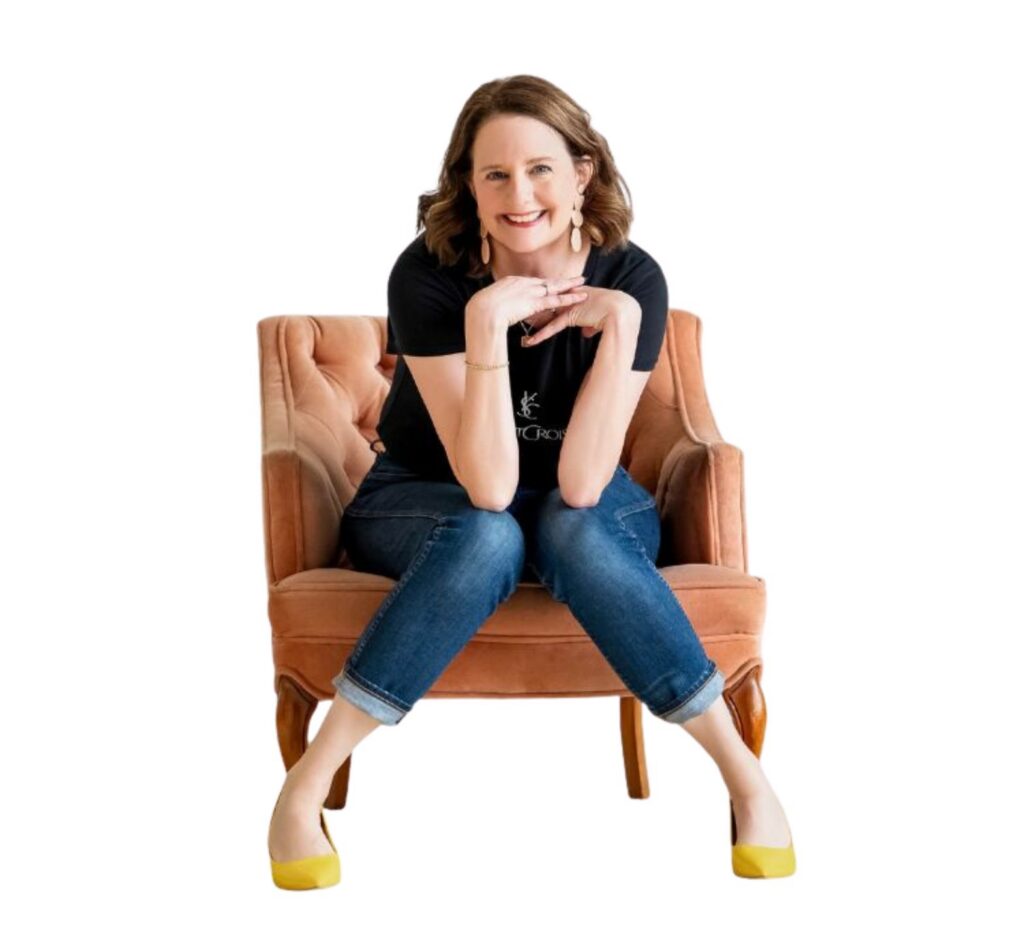 Annelise Bliss, a brand photographer in Portland, sitting in a chair with her hands up by her face.